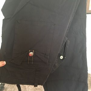 Black thin pocketed pants.